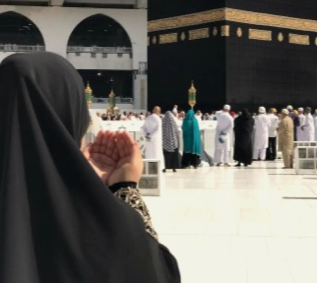 Hands raised in du'a facing the Ka'bah